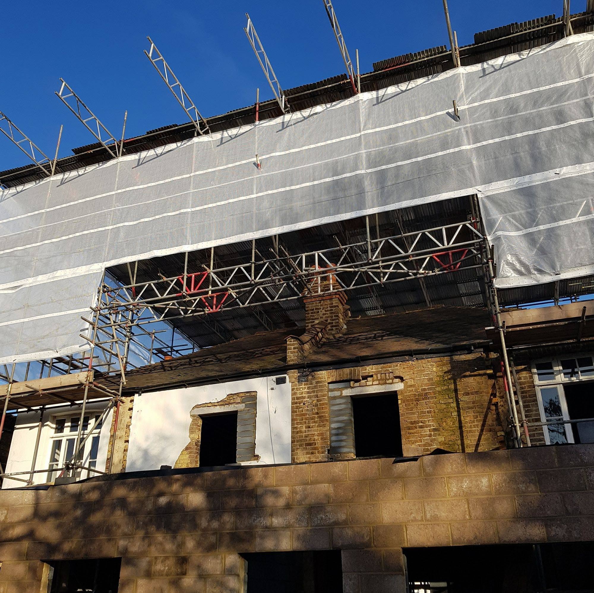 Terraced property with beamed temporary roof and monoflex shrink-wrap encapsulation